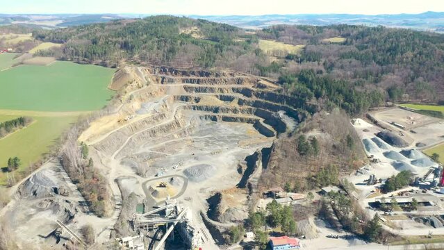 Stone quarry. Open cast mining. Industrial landscape. Heavy industry from above. Aerial view to big source of emissions.