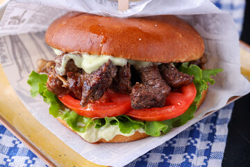 delicious fresh beef bits on a burger bun, with sauce