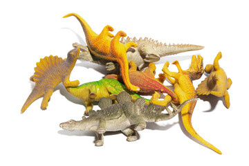 A group of some toy dinosaurs isolated on a white background.