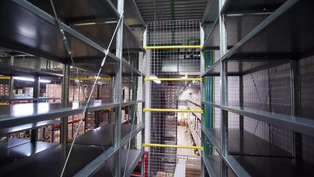 View inside of the inside of a large industrial facility. Creative. Stairs and shelves in a storage room.