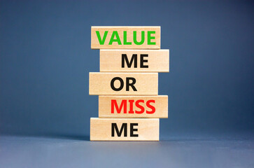 Value or miss me symbol. Concept words Value me or miss me on wooden block. Beautiful grey table grey background. Business psychological and value or miss me concept. Copy space.