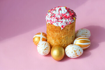 Easter Cakes - Traditional Kulich on a pink background. Paska Easter Bread in Russian letters XB ( Christ is Risen ).  Copy space. Side view.