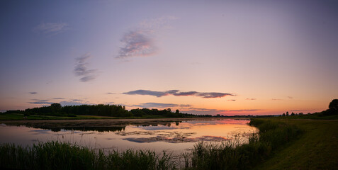 Colorful sunset over the lagoon near the fores