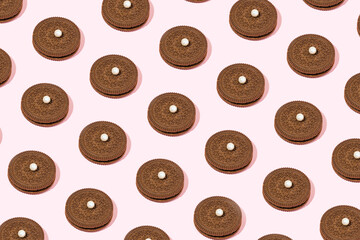 Cocoa cookies and pearl beads, creative sweet snack pattern.