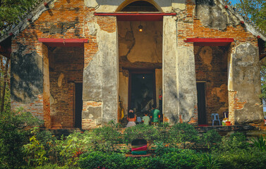 Backside of a family praying at temple in Ayutthaya, Thailand