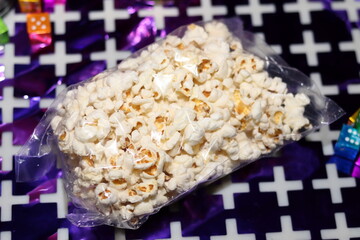 Salted popcorn in a small plastic bag and put on a table