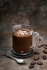Thick spicy hot chocolate in  glas cup on   dark  background