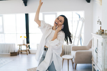 Joyful woman calling on smartphone