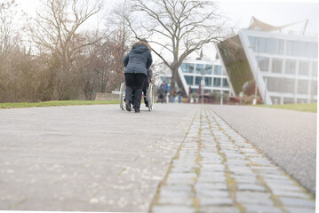 Naklejka premium a physically disabled person on a wheelchair at a walk.
