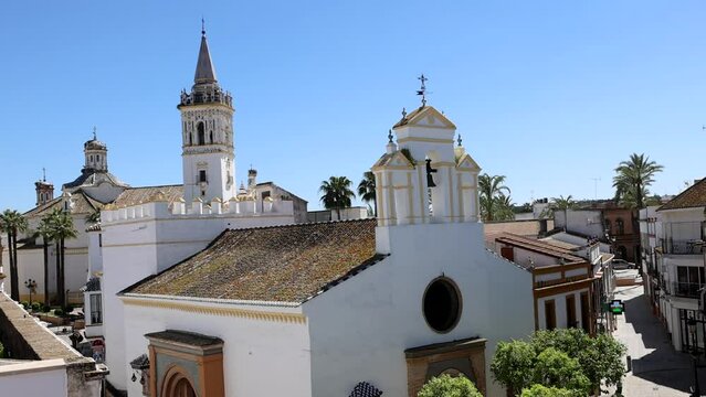 Aerial view of the Church of the Virgen del Valle in the foreground and the bell tower of the Parroquia San Juan Bautista in the municipality of La Palma del Condado, Huelva, Andalusia, Spain