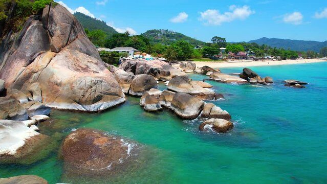 Hin Ta Hin Yai is a famous rock formation located on Koh Samui, Thailand. As seen from a drone, the rocks appear as two giant boulders protruding from the turquoise waters of the Gulf of Thailand.