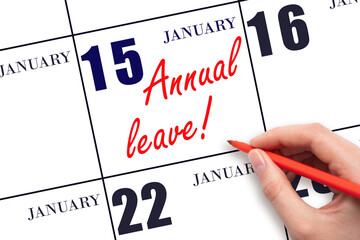 Hand writing the text ANNUAL LEAVE and drawing the sun on the calendar date January 15