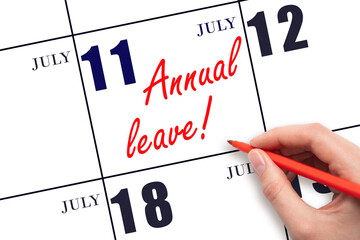Hand writing the text ANNUAL LEAVE and drawing the sun on the calendar date July 11