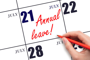 Hand writing the text ANNUAL LEAVE and drawing the sun on the calendar date July 21