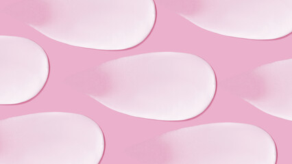 The background is cosmetic. Many smears of cream on a pink pink background