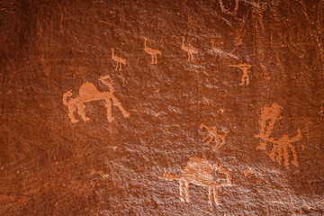 Wadi Rum, Jordan Ancient petroglyphs on a rock face depict camels and bird figures.