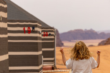 Wadi Rum Jordan A blonde woman checks into a desert cam accommodation. 