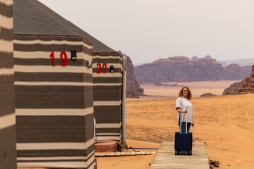 Wadi Rum Jordan A blonde woman checks into a desert cam accommodation. 