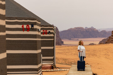 Wadi Rum Jordan A blonde woman checks into a desert cam accommodation. 