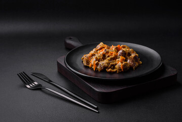 Delicious stewed chicken gizzards with carrots and tomato