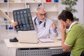 Young male patient visiting old male doctor radiologist