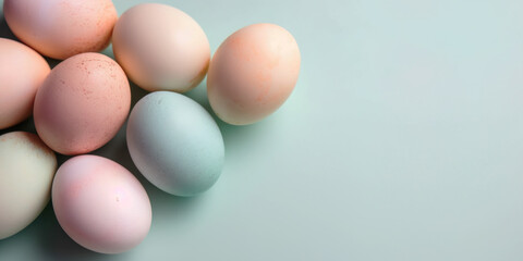 Pastel Easter eggs on blue background top view. Springtime holidays concept with copy space. Top view