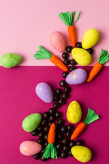 Chocolate and Easter Carrots on color Background