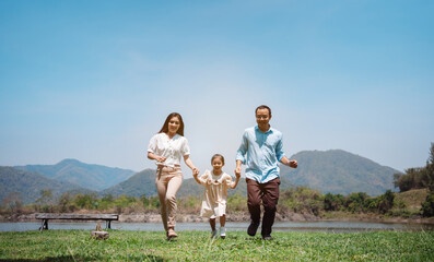 Happy family in the nature travel. family on weekend playing together in the meadow with river...
