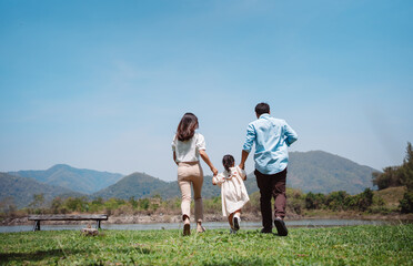 Happy family in the nature travel. family on weekend playing together in the meadow with river...