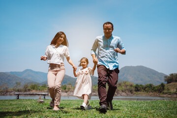 Happy family in the nature travel. family on weekend playing together in the meadow with river...