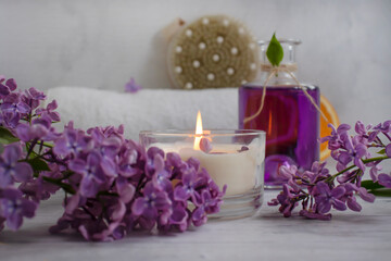Massage brush, lilac flower on a light background