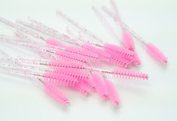 close up of pink brushes for combing eyelash extensions and brows