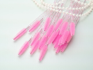 close up of pink brushes for combing eyelash extensions and brows