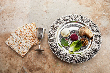 Composition with symbolic Passover, Pesach, items and meal on stone background,