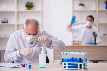 Two male chemist working at the lab