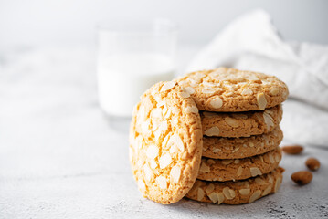 Cookies with almond slices and with a glass of milk