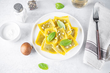 Fresh prepared Ravioli pasta with mushrooms and cheese in a plate