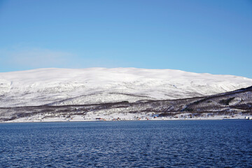 Naklejka na ściany i meble snowy landscape view in tromso fjords, norway