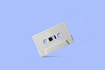 Blank audio cassette tape on colored background, vintage audio magnetic tape