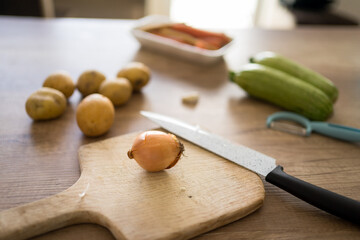 Close-up photo of chopped vegetables on the wooden table. Preparing a vegan meal.
