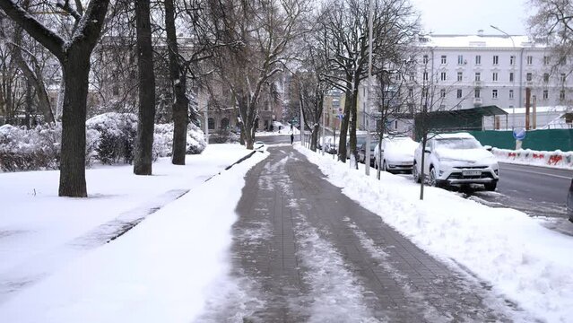 MINSK, BELARUS - March 29, 2023: Streets of spring Minsk in the snow, slow motion, first-person view 4k