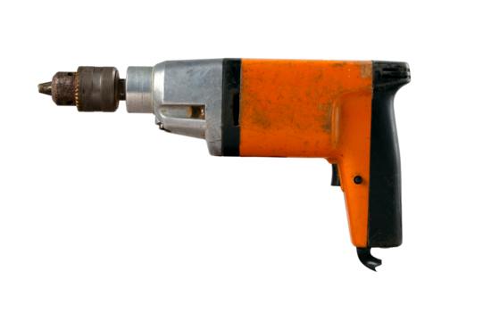 An old electric drill used in home workshops for minor repair work. Isolated background.
