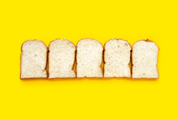 Bread slices on yellow background.