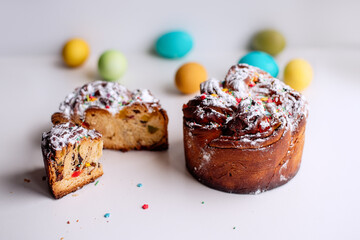 Easter Kraffin on a light background with colored, bright eggs. Cake with raisins, chocolate, nuts