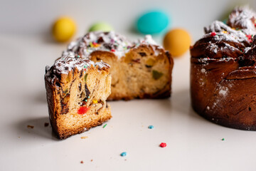 Easter Kraffin on a light background with colored, bright eggs. Cake with raisins, chocolate, nuts