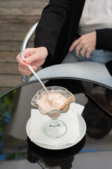 Fototapeta na wymiar faceless photo business woman thoughtfully notes melted ice cream in a bowl
