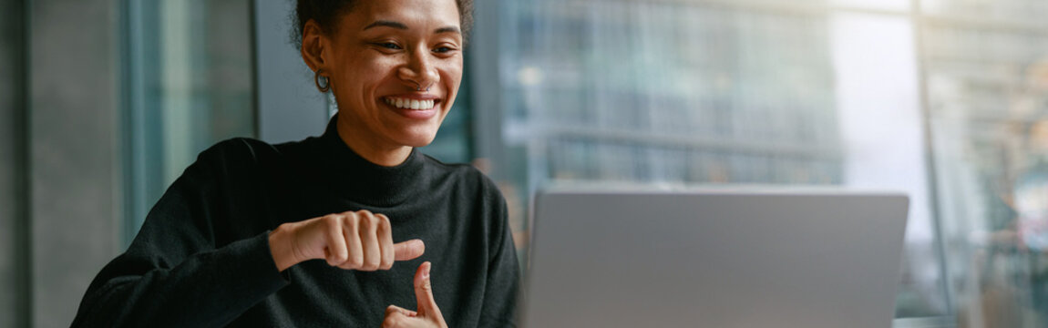 Woman freelance architect talking with client via video call and discuss project sitting in cafe