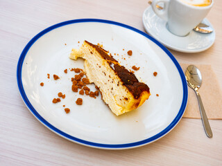 Piece of delicious cheesecake dessert served on plate on table