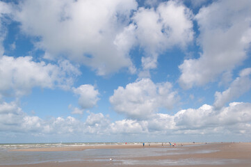 Clear blue sky and white dynamic clouds over the sea, view of the horizon
