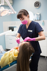 Doctor dentist treats the teeth of a patient in a hospital.